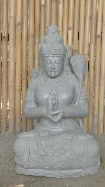 Product image of the product “Seated Dewi Sri, position chakra turning the wheel, 73cm high riverstone grey, model with sativa. There is a stone eye on the left temple. ”